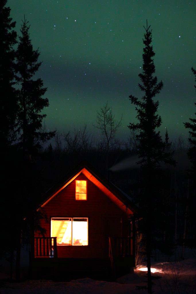 Yukon Cabin with Northern Lights in the sky